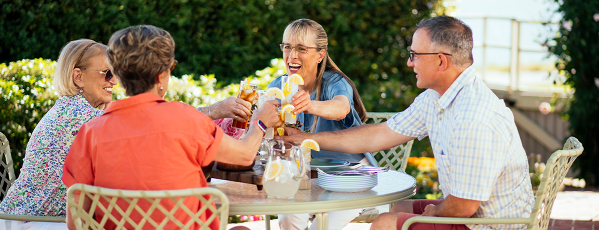 Image of middle aged woman toasting with friends at an outdoor gathering